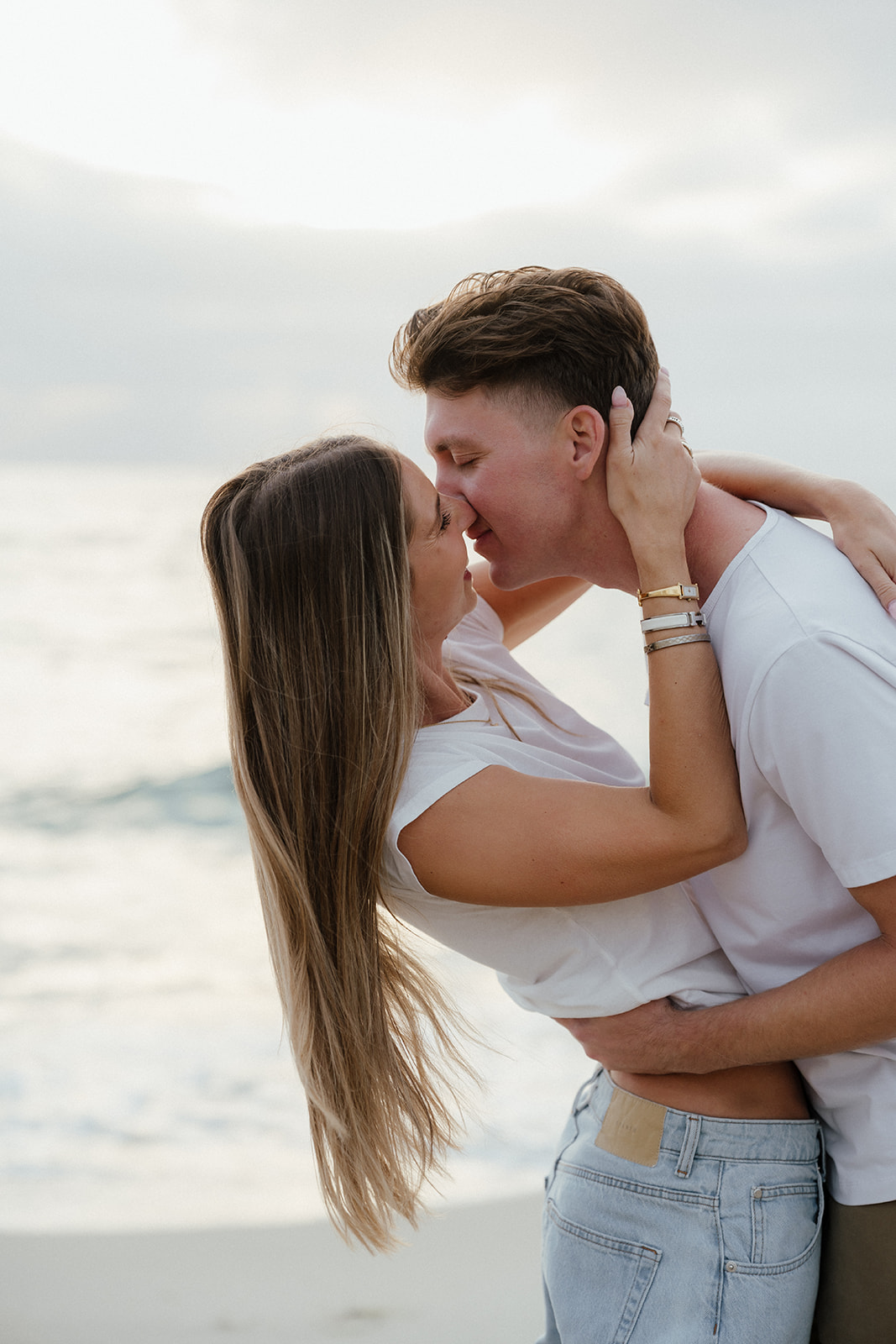 Newly engaged couple during beach engagement photos in San Diego